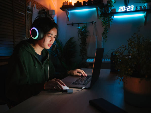 istock Young man playing video game inside a room at home. 1249868470