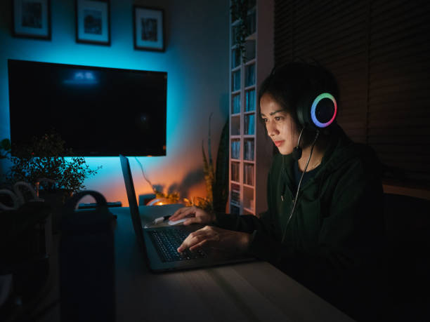 istock Young man playing video game inside a room at home. 1249868476