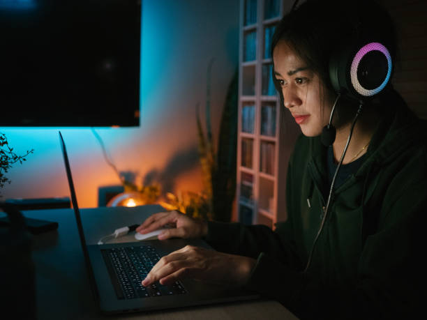 istock Young man playing video game inside a room at home. 1249868504