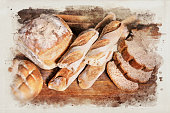 Variety of bread and baguette at bakery on wooden table