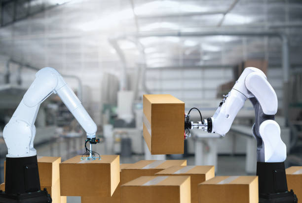 istock Robotic arms carries cardboard box 1249871208