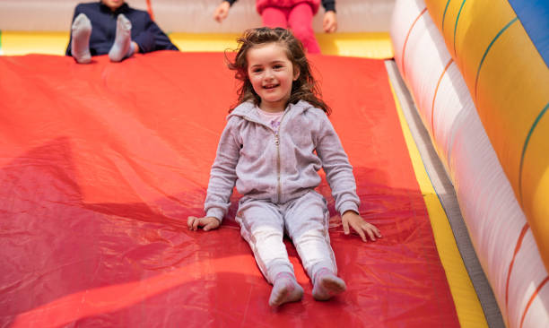 istock Little girl playing on inflatable playground 1249872038