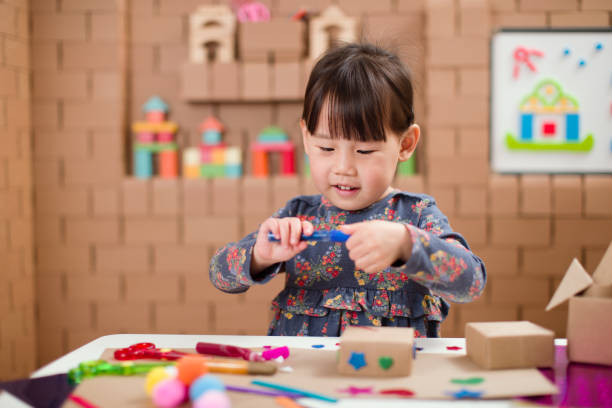 istock toddler girl  making craft by using cardboard for homeschooling 1249872496