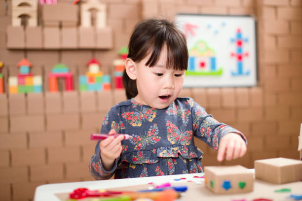 istock toddler girl  making craft by using cardboard for homeschooling 1249872539