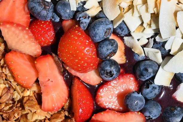 Acai bowl with fruits, granola and flakes