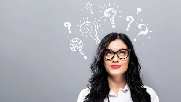 istock Question marks with young businesswoman 1249876134