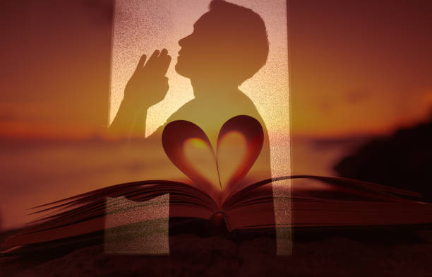 istock Young man looking up praying to god. 1249878948