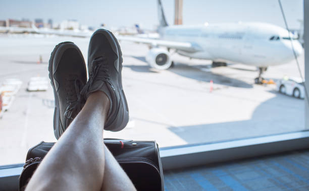 istock Person waiting for flight at airport terminal. 1249878984