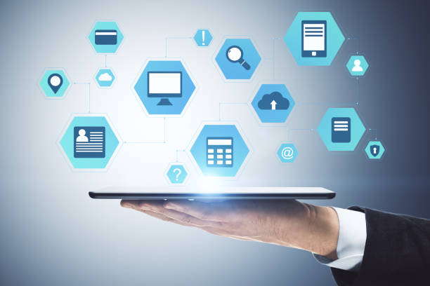 istock Hand holding digital tablet with business interface hologram. 1249879115