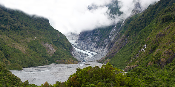 Franz Josef Glacier in Westland Tai Poutini National Park on the West Coast of New Zealand's South Island. The river emerging from the glacier terminal of Franz Josef is known as the Waiho River. Retreating glacier;