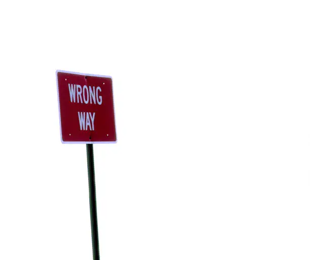 A wrong way sign shot with over-exposed background.