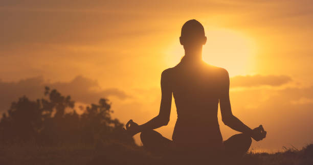 istock Woman meditating in the park 1249880464