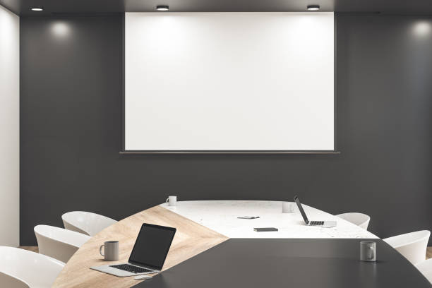 istock Clean meeting room interior with blank tv screen 1249880737