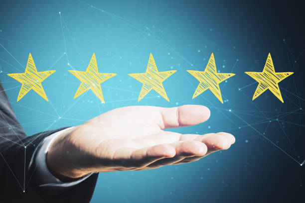 istock Hand holding yellow star rating on virtual screen 1249881035
