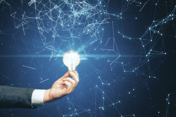 istock Businessman hand holding light bulb 1249882296
