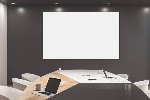 istock Minimalistic conference room with blank poster on wall. 1249882385