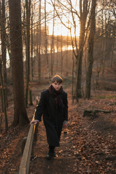 istock Portrait of a young man walking in forest alone 1249883748