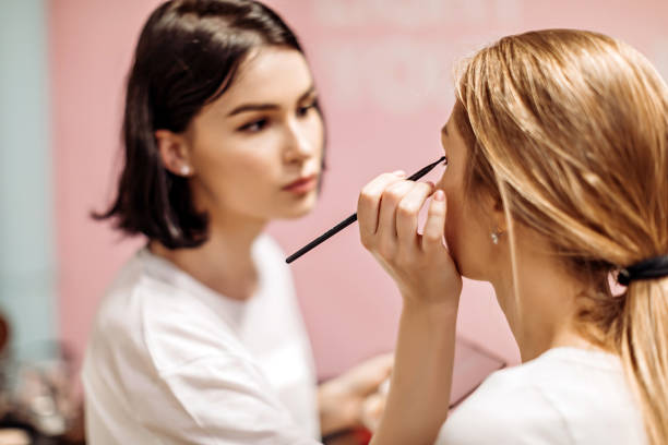 Make-up artist at work at a fashion show Make-up artist at work at a fashion show. aesthetician photos stock pictures, royalty-free photos & images