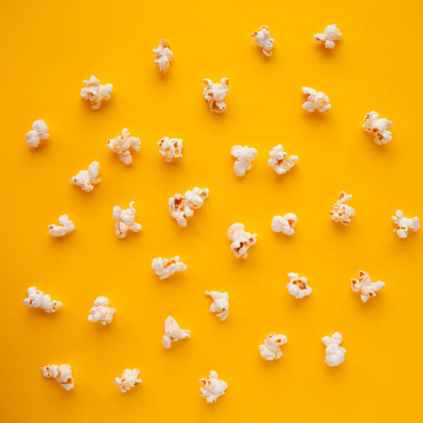 istock delicious popcorn scattered on a yellow background 1249885568