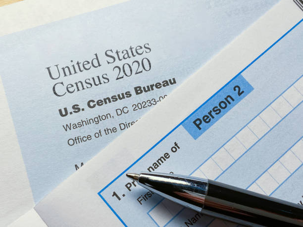 istock Census 2020: survey form on desk in office with envelope 1249888785