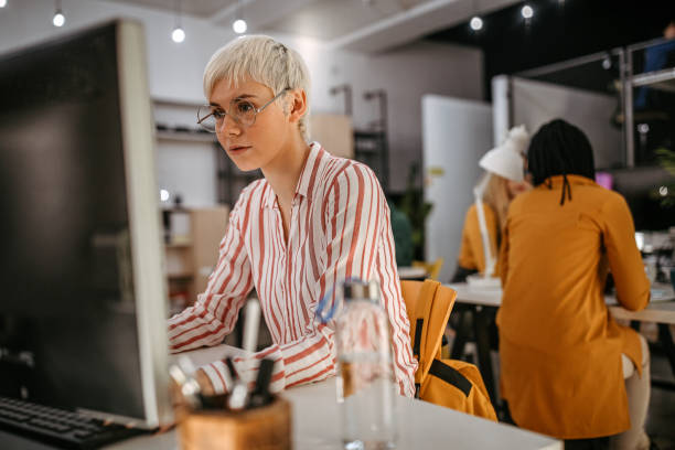 istock Short haired young woman working in office 1249888957