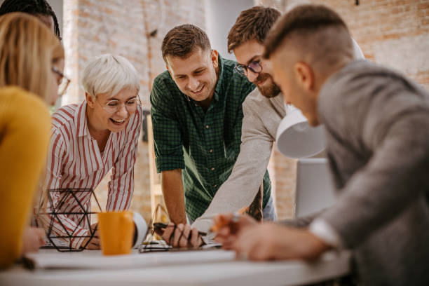 istock Multi-ethnic group of people enjoying at office 1249889689