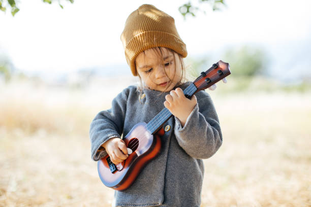 istock Litlle girl playing guitar 1249889732