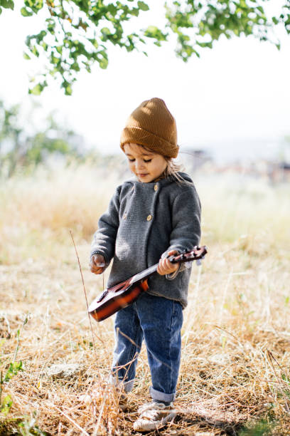 istock Litlle girl playing guitar 1249889844