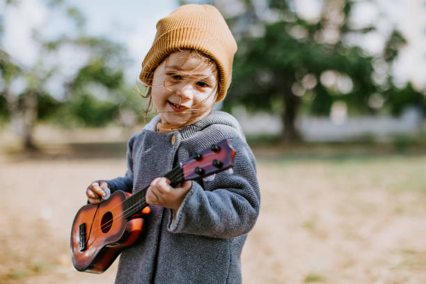 istock Litlle girl playing guitar 1249889869