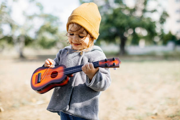 istock Litlle girl playing guitar 1249889929