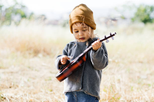 istock Litlle girl playing guitar 1249889997