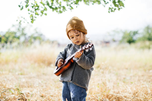 istock Litlle girl playing guitar 1249890022