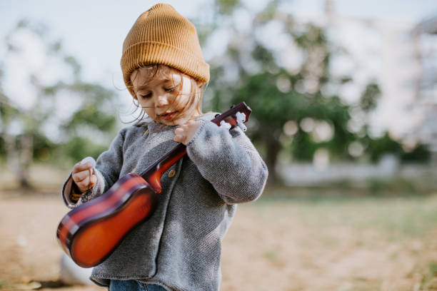 istock Litlle girl playing guitar 1249890657