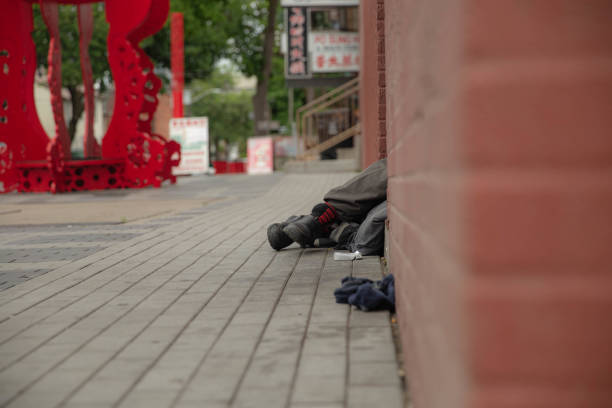 In downtown Toronto, a homeless man sleeps in a hidden entrance in order to achieve a semblance of normalcy.