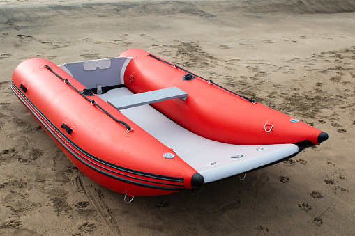 Inflatable boat on the beach red in color
