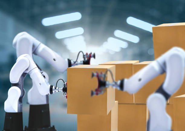 istock Robotic arms carries cardboard box 1249898375