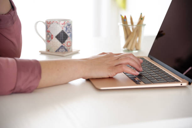 istock Woman working on her gold laptop 1249899577