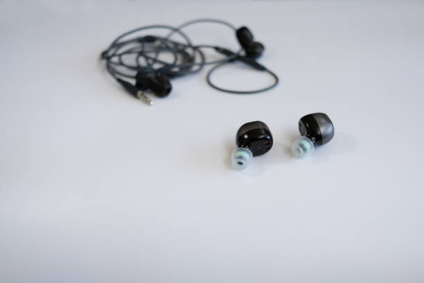 istock True wireless earbuds in the front of wired headphone 1249900927