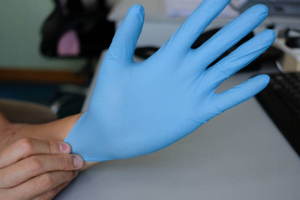 istock A worker wearing a nitrile gloves for working in his office. Aims for has better prevention for virus. 1249900929