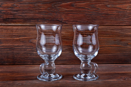 Two empty gluhwein glasses on a wooden background. Copy space.