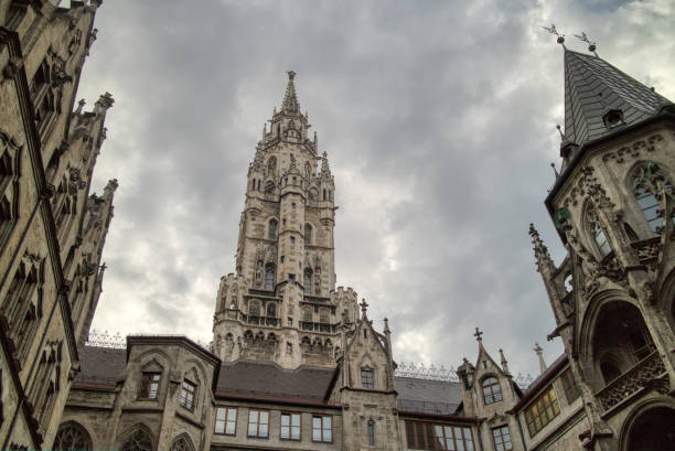 istock Old-fashioned architectural buildings against grey cloudy sky in Munich, Germany. 1249902459