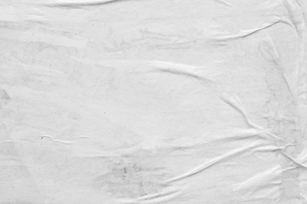 istock Blank white crumpled and creased paper poster texture background 1249904101