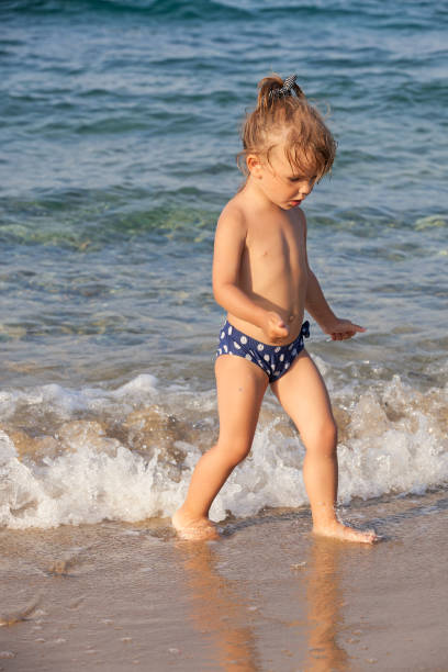 istock little girl runs in the shallows 1249909870
