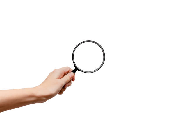 Femal hand holding magnidying glass. Detective and searchConcept. White background, isolated, close up Femal hand holding magnidying glass. Detective and searchConcept. White background, isolated, close up magnifying glass stock pictures, royalty-free photos & images