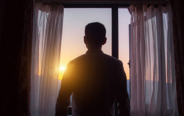 istock Businessman looking sunrise standing by window 1249923501