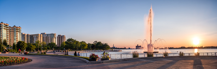 Windsor, Ontario, Canada - June 15, 2020:  The Peace Fountain is located in Reaume Park (public park) in Windsor, Ontario, Canada.  It is on the Detroit River.  Across the river is Detroit, Michigan, USA.  The Peace Fountain is one of Windsor's premiere tourist attractions.  It typically operates between May and October and shoots water into the air in various formations.  At night, it is illuminated with colourful lights.