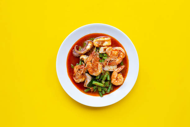 istock Spicy stir fried seafood and yard long bean with red curry paste. Thai food 1249939236