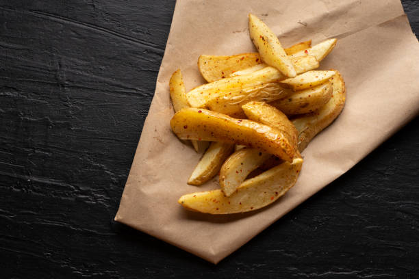 istock French fries on dark background 1249940760