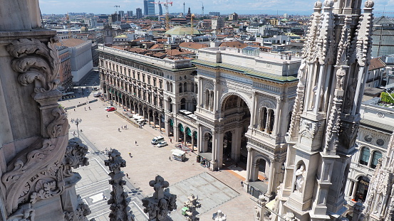 Milano, Italy. The entrance to the famous Vittorio Emanuele shopping mall from the top of the Duomo. The spires of the Duomo in white marble