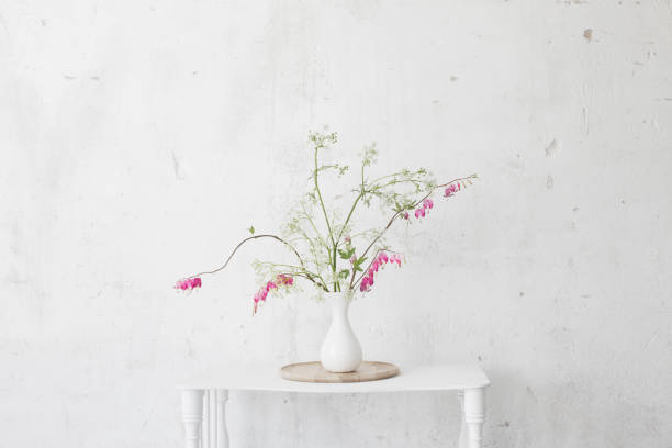istock flowers in vase on background white wall 1249947599
